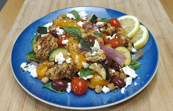 Mediterranean air fryer chicken with peppers, olives, tomatoes, and feta