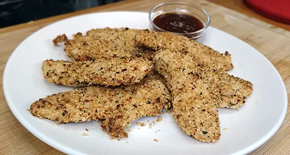 Crispy panko-coated air fryer chicken tenders served with dipping sauce